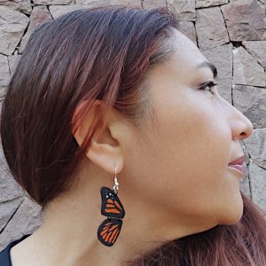 A woman wearing our Monarch butterfly earrings