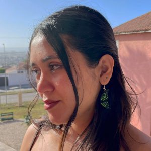 A woman wearing our Tailed Jay butterfly earrings.